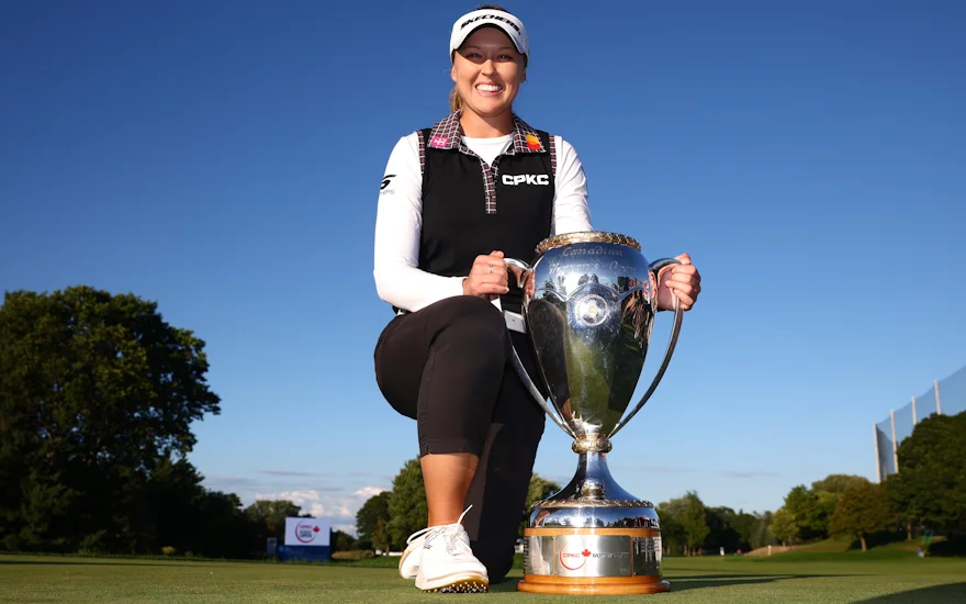 Brooke Henderson Wins and Poses With CPKC Women's Open Trophy.